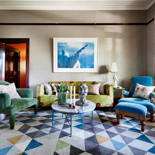 Design ideas for an eclectic living room in Sydney with medium hardwood floors, brown floor and beige walls.