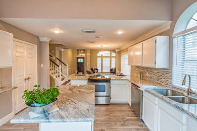 Inspiration for a mid-sized timeless u-shaped light wood floor and beige floor open concept kitchen remodel in Salt Lake City with a double-bowl sink, raised-panel cabinets, white cabinets, granite countertops, beige backsplash, matchstick tile backsplash, stainless steel appliances and an island