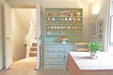 Example of a cottage chic dining room design in London