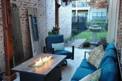 Inspiration for a small transitional side yard patio in Dallas with a fire feature, concrete pavers and an awning.