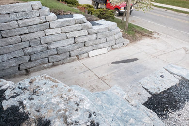 Design ideas for a large rustic hillside stone landscaping in Toronto.