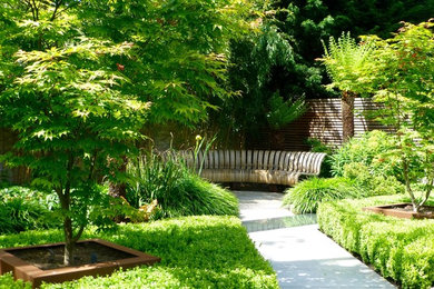 Photo of a mid-sized contemporary backyard partial sun garden for summer in London.