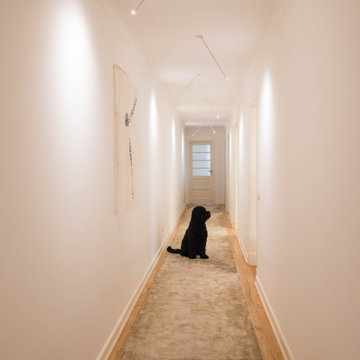 Long Corridor with Runner Rug and Linear Ceiling Lights in Lisbon