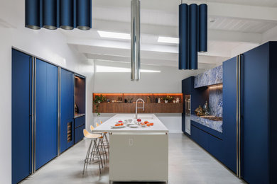 Inspiration for a mid-sized contemporary concrete floor, gray floor and exposed beam eat-in kitchen remodel in Los Angeles with an integrated sink, flat-panel cabinets, blue cabinets, granite countertops, blue backsplash, granite backsplash, stainless steel appliances, an island and blue countertops