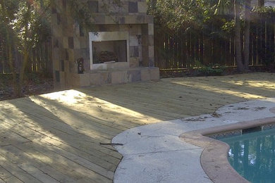 Inspiration for a large transitional backyard patio remodel in Houston with a fireplace and decking