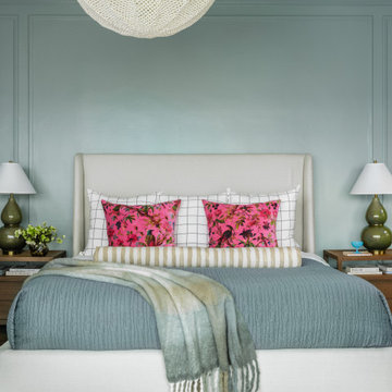 Primary Bedroom with Light Blue Walls and Colorful Layered Bedding