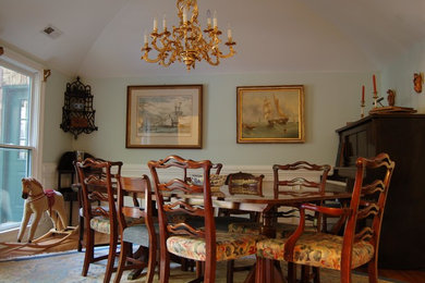 Inspiration for a timeless light wood floor and beige floor enclosed dining room remodel in Charlotte with gray walls