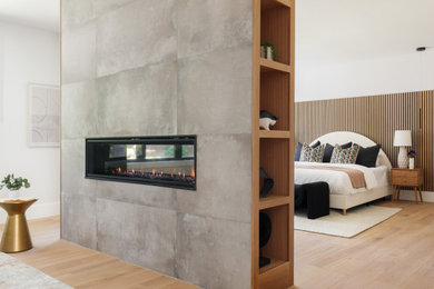 Example of a large trendy master bedroom design in Boston with a two-sided fireplace