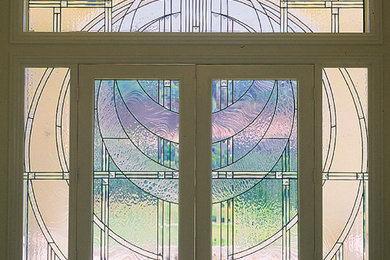 Inspiration for a mid-sized contemporary entryway remodel in Other with beige walls and a light wood front door