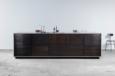 Norm Design with bronzed tombac fronts and a concrete worktop