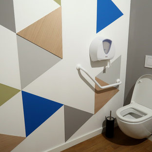 Large urban enclosed vinyl floor and brown floor home theater photo in Montpellier with multicolored walls