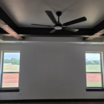 Trey ceilings with massive wood beams & large windows enrich the Primary/Master