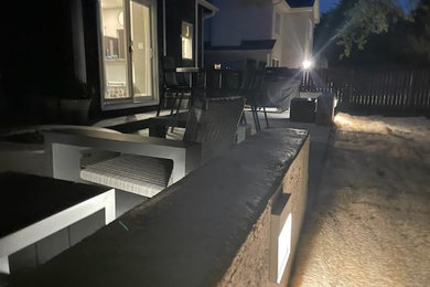 Backyard concrete patio photo in Other with no cover