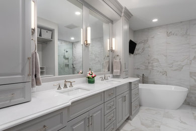 Inspiration for a large transitional master white tile and porcelain tile porcelain tile, white floor and double-sink bathroom remodel in St Louis with raised-panel cabinets, gray cabinets, gray walls, an undermount sink, quartz countertops, white countertops and a built-in vanity