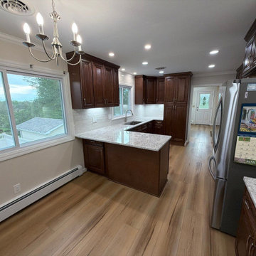 USCD cabinetry accompanied granite countertops, porcelain tile backsplash and Ca