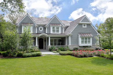 Example of a classic gray two-story wood gable roof design in Chicago