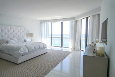 Large master bedroom in Miami with white walls and marble floors.
