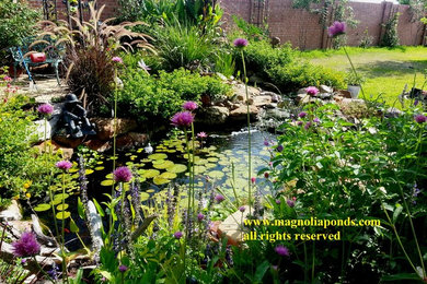 Inspiration for a mid-sized traditional partial sun backyard stone water fountain landscape in Houston.