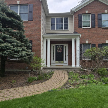 Brick Front Entrance with Curved Walkway and Landscaping