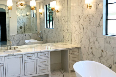 Design ideas for an expansive modern master bathroom in Denver with beaded inset cabinets, white cabinets, a freestanding tub, a double shower, a two-piece toilet, white tile, marble, white walls, marble floors, an undermount sink, marble benchtops, white floor, an open shower and white benchtops.
