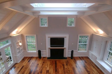 Large elegant loft-style living room photo in Philadelphia with a standard fireplace and a wood fireplace surround
