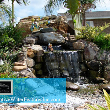 Large backyard waterfall with pond