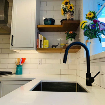 ikea white cabinets with subway tile backsplash and floating shelves