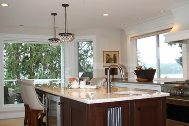Example of a mid-sized transitional l-shaped light wood floor kitchen design in Seattle with an undermount sink, shaker cabinets, dark wood cabinets and an island