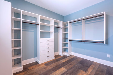 Walk-in closet - coastal walk-in closet idea in Burlington with flat-panel cabinets and white cabinets