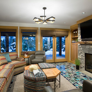 This is an example of a medium sized rustic home cinema in Other with grey walls, ceramic flooring, a wall mounted tv and turquoise floors.