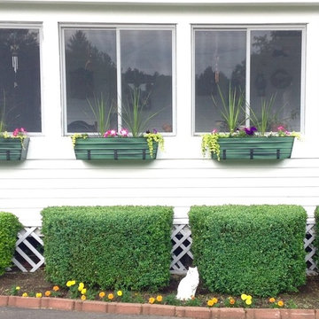 Rock Rich- windowboxes border the enclosed porch along the drive