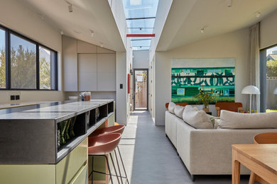 Large contemporary living room in Cornwall with white walls, concrete flooring and grey floors.
