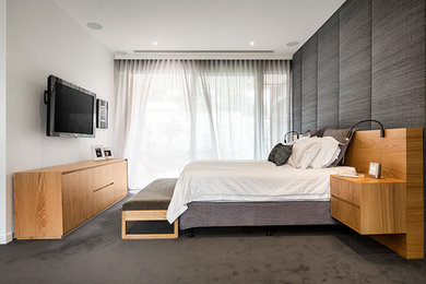 This is an example of a contemporary bedroom in Melbourne.