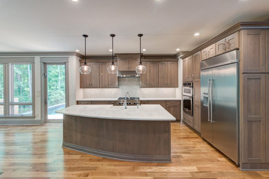Example of an arts and crafts l-shaped light wood floor eat-in kitchen design in Raleigh with quartz countertops, white backsplash, ceramic backsplash, stainless steel appliances, an island and white countertops