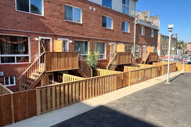Inspiration for a huge partial sun courtyard wood fence outdoor basketball/tennis/multi-game court in Toronto with decking for summer.