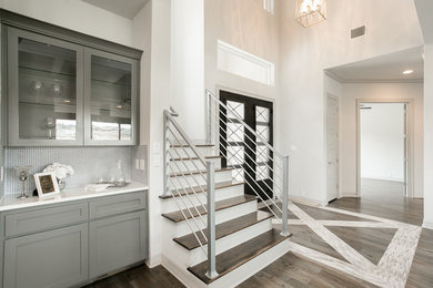 Entryway - large contemporary light wood floor and brown floor entryway idea in Austin with white walls and a brown front door