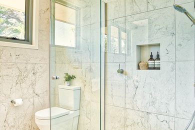 Inspiration for a mid-sized modern master bathroom in Geelong with light wood cabinets, a two-piece toilet, black and white tile, porcelain tile, multi-coloured walls, porcelain floors, an undermount sink, engineered quartz benchtops, multi-coloured floor and a hinged shower door.