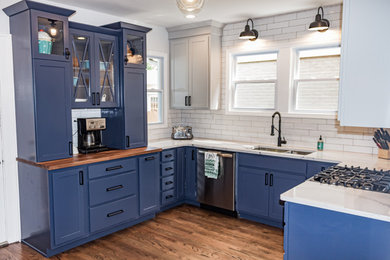 Inspiration for a small transitional u-shaped medium tone wood floor and brown floor eat-in kitchen remodel in St Louis with an undermount sink, shaker cabinets, blue cabinets, quartz countertops, white backsplash, subway tile backsplash, stainless steel appliances and white countertops