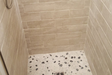 Small minimalist beige tile and ceramic tile ceramic tile and gray floor doorless shower photo in New York with white countertops