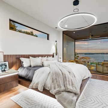 Modern Luxury Lakehouse Master Bedroom with Panoramic Lake Views and Modern Ligh