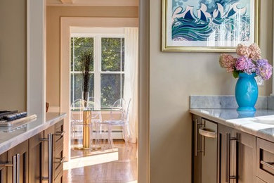 Example of a mid-sized transitional light wood floor and brown floor kitchen design in Other with shaker cabinets, medium tone wood cabinets, marble countertops, paneled appliances and an island