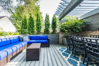 This is an example of a medium sized modern roof terrace in Chicago with a pergola.