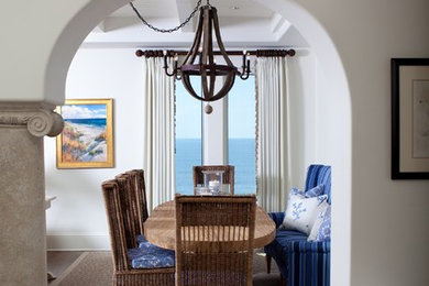 Example of a mid-sized beach style medium tone wood floor and brown floor enclosed dining room design in Atlanta with white walls and no fireplace