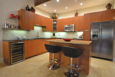 Example of a trendy porcelain tile kitchen design in Miami with flat-panel cabinets, medium tone wood cabinets, granite countertops, stainless steel appliances and an island