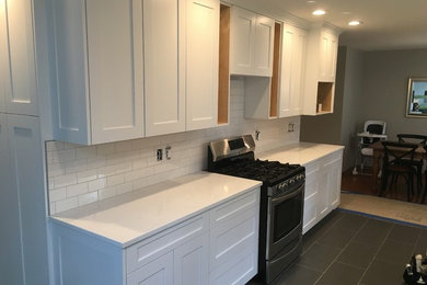 Eat-in kitchen - mid-sized craftsman galley eat-in kitchen idea in Portland with shaker cabinets, white cabinets, quartz countertops and no island