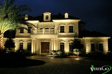 Photo of a mediterranean front yard brick driveway in Orlando.