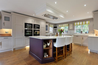 Inspiration for a large contemporary u-shaped kitchen/diner in Other with a built-in sink, shaker cabinets, grey cabinets, marble worktops, grey splashback, stone tiled splashback, stainless steel appliances, medium hardwood flooring and an island.