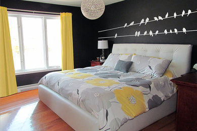 Small transitional master medium tone wood floor bedroom photo in Montreal with black walls