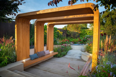 Entrance into garden framed by water feature timber canopy