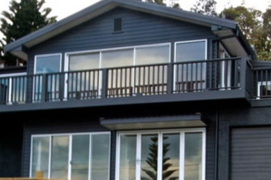 Photo of a beach style two-storey black exterior in Wollongong.